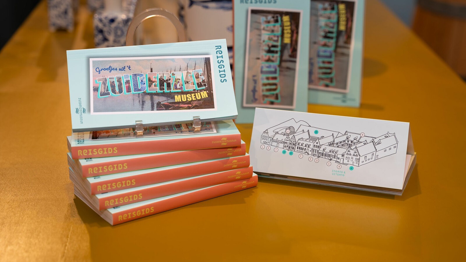 Een stapeltje met Zuiderzeereisgidsen, met daarbij een kaart van het Schathuys