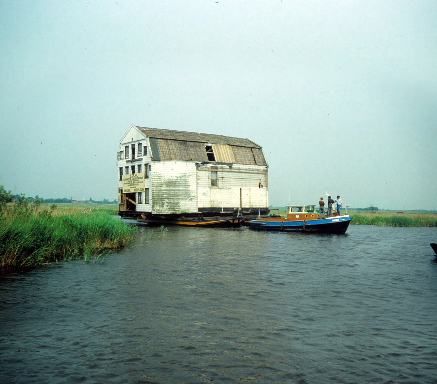 In 1980 wordt het kaaspakhuis op een boot geladen en over het water naar het Zuiderzeemuseum vervoerd.